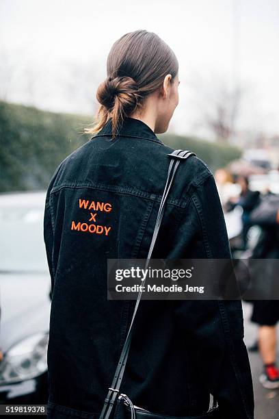 American Model Vanessa Moody wears her hair in a low loose bun and wears a black Alexander Wang "Wang x Moody" black denim jacket after the Bottega...