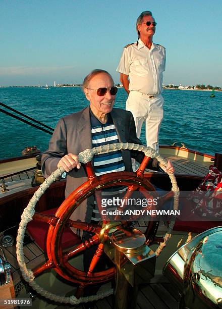 Geidar Aliev, president of Azerbaijan, takes the helm of the Schooner America 05 April 2001, during a planned cruise around Key West Harbor as a part...