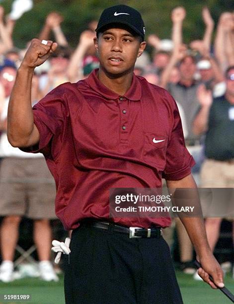 Tiger Woods of the US reacts to making the final putt on the 18th hole in the final round of the 2001 Masters Golf Tournament at the Augusta National...