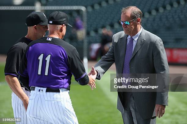 Colorado Rockies owner Dick Monfort greets bench coach Tom Runnells and manager manager Walt Weiss during batting practice prior to facing the San...