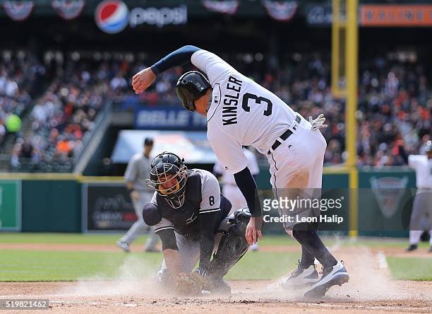 Ian Kinsler of the Detroit Tigers slides home safe on the Miguel Cabrera single to right field as Austin Romine of the New York Yankees attempts to...