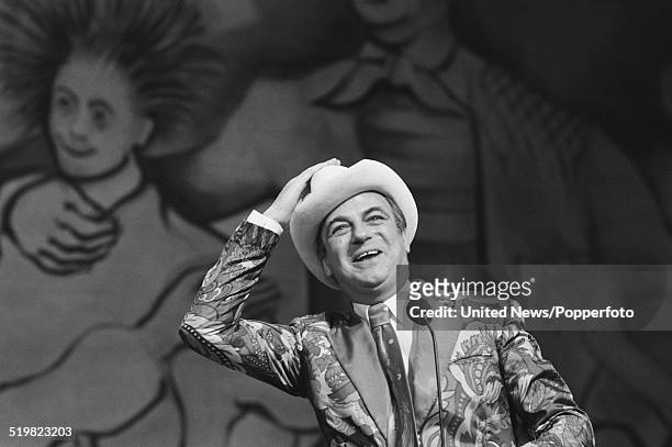 English comedian and actor Roy Hudd performs on stage at the Palladium in London during rehearsals prior to his performance on the Royal Variety Show...