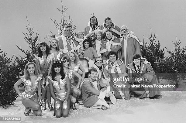 Group shot of various comedians, actors, dancers and television presenters, dressed in festive costumes, taking part in a photo call to promote BBC...