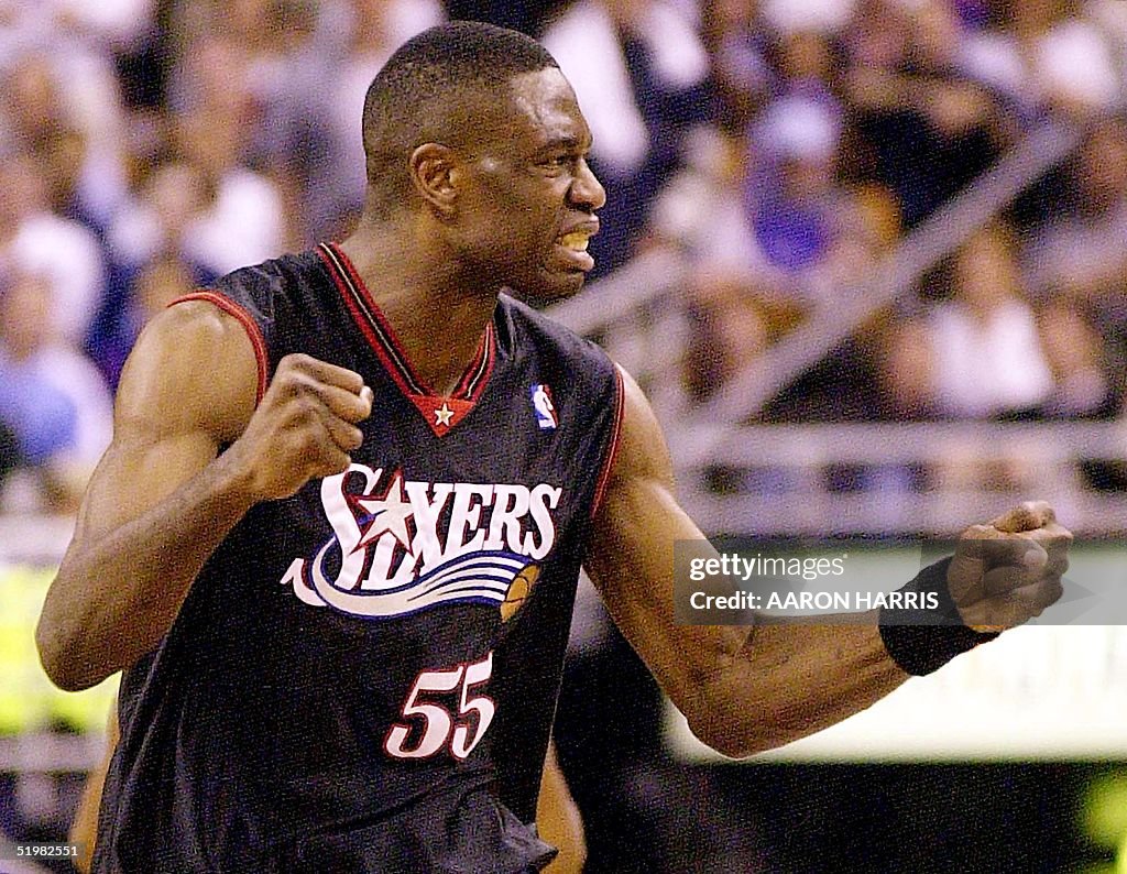 Philadelphia 76ers' Dikembe Mutombo celebrates a p