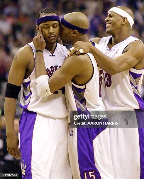 Toronto Raptors Vince Carter and Jerome Williams congratulate teammate Morris Peterson after making a basket during second half action of game six of...