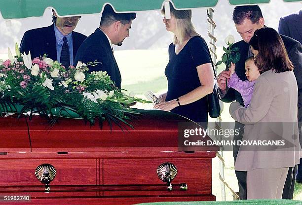 Delinah Blake , daughter of actor Robert Blake, holds Rose Lenore Sophie Blake, daughter of Blake and Bonny Lee Bakley, near the coffin bearing...