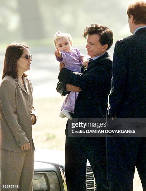 Actor Robert Blake holds Rose Lenore Sophie Blake, his daughter with his slain wife, Bonny Lee Bakley, during a brief funeral ceremony for Bakley in...