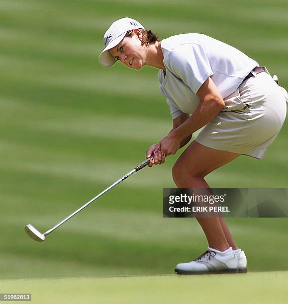 Golfer A.J. Eathorne of Canada watches her par putt go in on the 18th hole 31 May, 2001 as she finishes the first round of the US Women's Open at the...