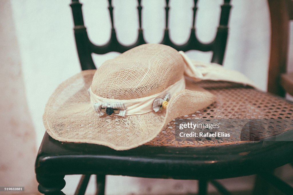 Vintage wide brimmed sun hat on wooden chair