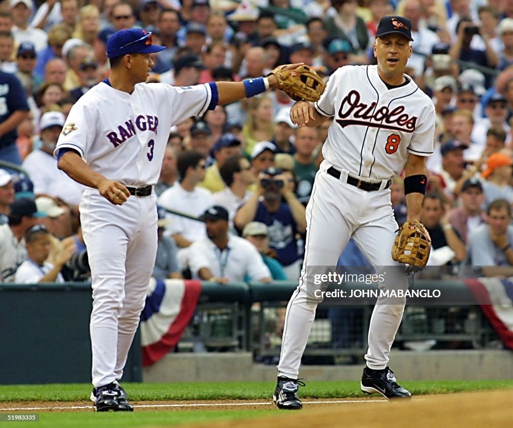 Cal Ripken Jr., (R) of the Baltimore Orioles, aske