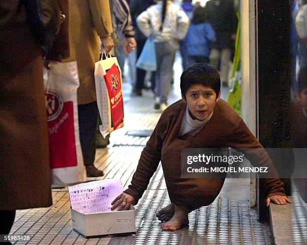 Child seeks alms on the street 20 July 2001 in Buenos Aires, Argentina. Argentina has experienced nearly three years of economic recession, with...