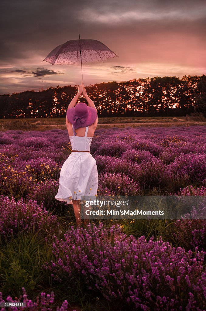 Woman with umbrella in the lavender field
