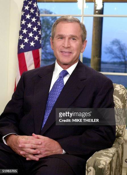 President George W. Bush poses for photographers after making his nationwide address in which he backed federal funding for limited embryonic stem...