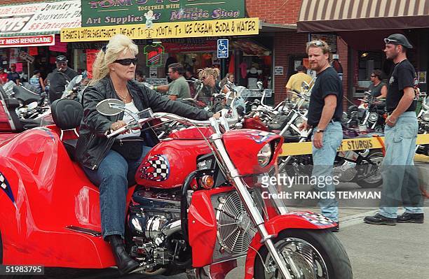 An unidentified female biker rolls down main street during the 61st annual motorcycle rally held 06-12 August, 2001 in Sturgis, South Dakota....