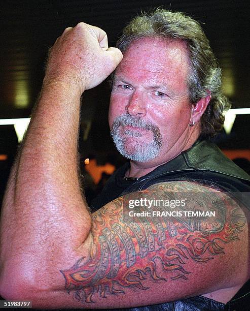 An unidentified biker shows off his tattoo during the 61st annual motorcycle rally held 06-12 August, 2001 in Sturgis, South Dakota. Thousands of...