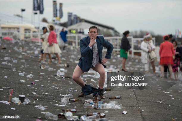 Racegoer poses as he prepares to leave Ladies Day, the second day of the Grand National Festival horse race meeting at Aintree Racecourse in...