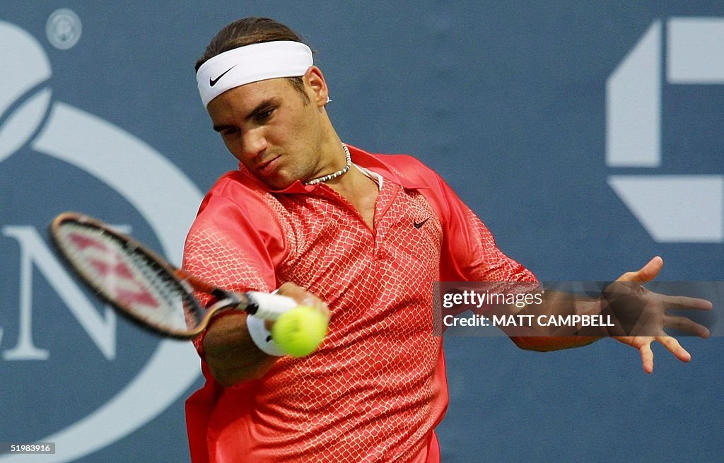 Roger Federer of Switzerland returns to Lars Burgs