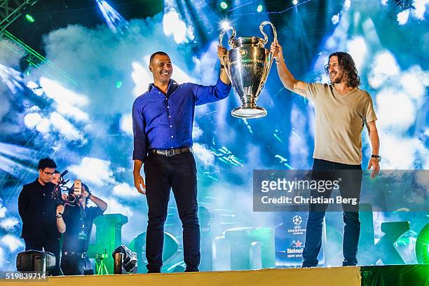 Ruud Gullit and Carles Puyol hold the UEFA trophy at the UEFA Champions League Trophy Tour on April 8, 2016 in Ho Chi Minh City, Vietnam.