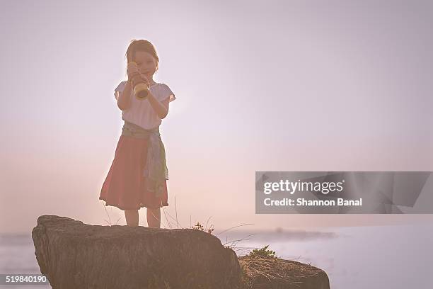 young girl on rock at ocean at sunset - female pirate stock pictures, royalty-free photos & images