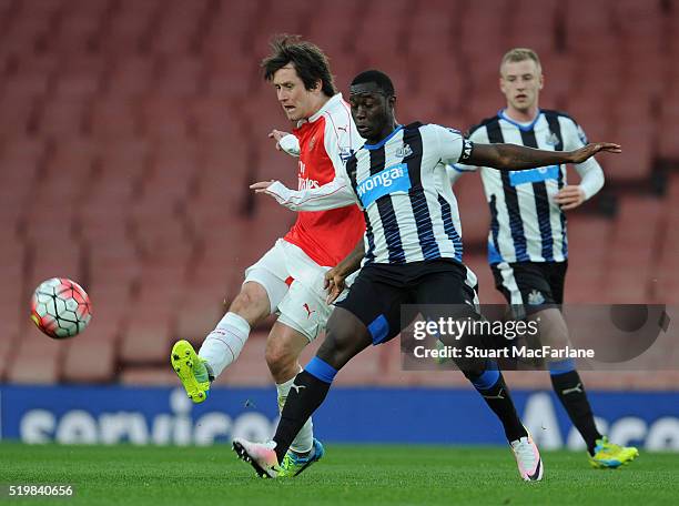 Tomas Rosicky of Arsenal breaks past Henri Saivet of Newcastle during the Barclays Premier League match between Arsenal and Newcastle United at...