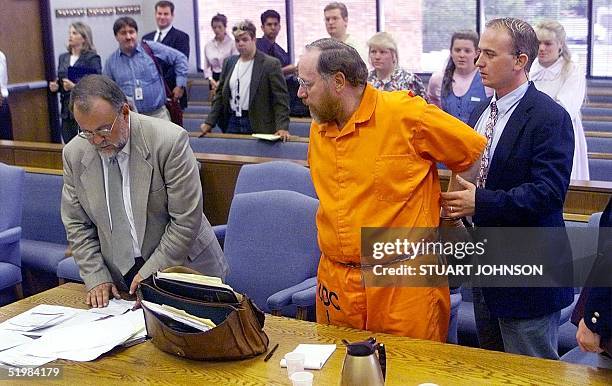 Tom Green , convicted on four counts of bigamy and one count of criminal nonsupport, talks to his attorney John Bucher while being taken back into...