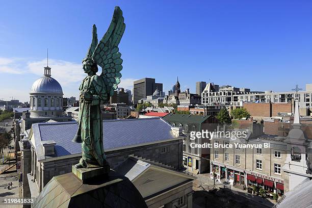 angel statue and old montreal - vieux montréal stock-fotos und bilder