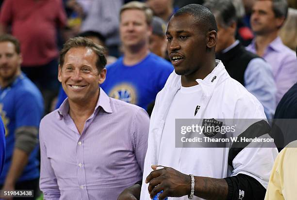 Oakland Raiders defensive end Aldon Smith looks on from the stands prior to the start of an NBA Basketball game between the San Antonio Spurs and...