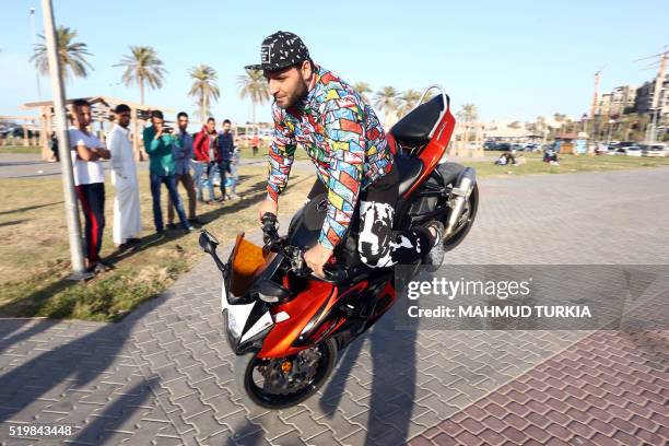 Libyan motorcyclists performs a stoppie, or a front wheelie, in the capital Tripoli on April 8, 2016.