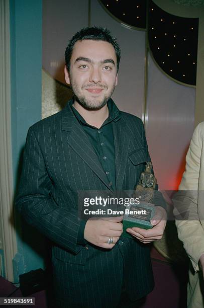 Jez Butterworth holding the Charles Wintour Award for Most Promising Playwright, for his play, 'Mojo', at the Evening Standard Theatre Awards, held...