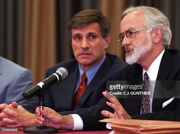 United States Attorney James B. Farmer refuses to answer a reporter's question as the FBI's Special Agent in Charge Charles Prouty, looks on during a...