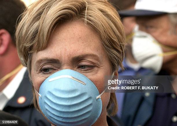 Sen. Hillary Rodham Clinton, Democrat of New York, wears a dust mask while touring the site of the World Trade Center 12 September one day after a...