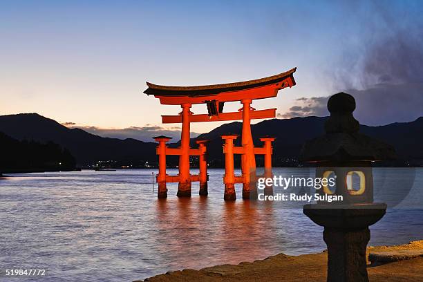 torii gate at the itsukushima jinga shrine - torii gate stock pictures, royalty-free photos & images