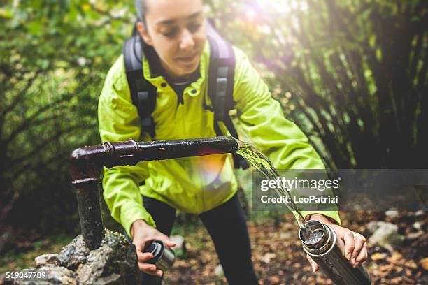 source of water in mountain - filling stock pictures, royalty-free photos & images