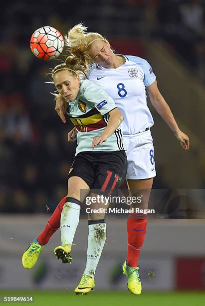 Katie Chapman of England wins a header over Janice Cayman during the UEFA Women's European Qualifer between England and Belgium at The New York...