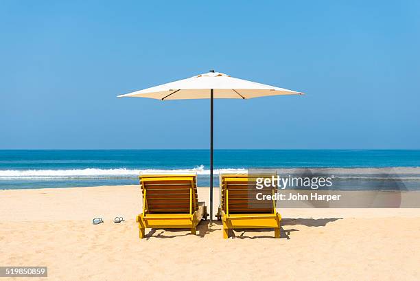 idyllic beach scene - parasols stockfoto's en -beelden