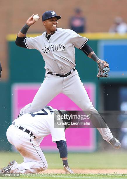 Andrew Romine of the Detroit Tigers slides into second base safe as Starlin Castro of the New York Yankees attempts to make the play during the eight...