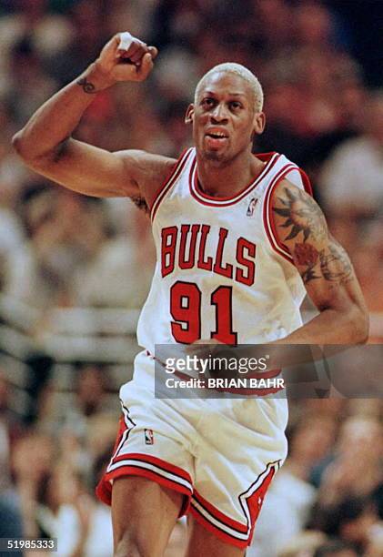 Chicago Bulls forward Dennis Rodman pumps his fist as he heads up the court in the fourth quarter of game one of the NBA Eastern Conference finals at...