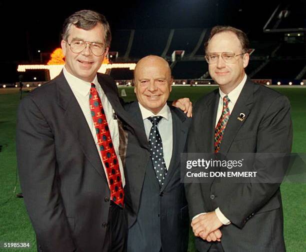 Officials pose for photographers after turning the lights on at Atlanta's Olympic Stadium 17 May. Billy Payne, president and chief executive officer...