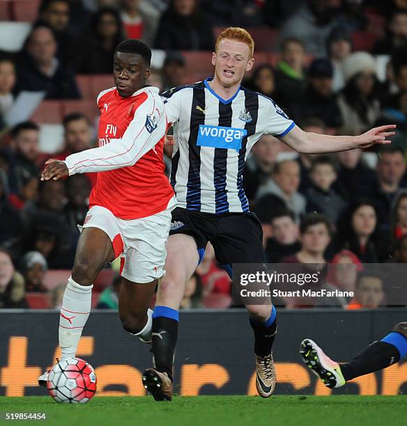 Stephy Mavididi of Arsenal breaks past Callum Williams of Newcastle during the Barclays Premier League match between Arsenal and Newcastle United at...