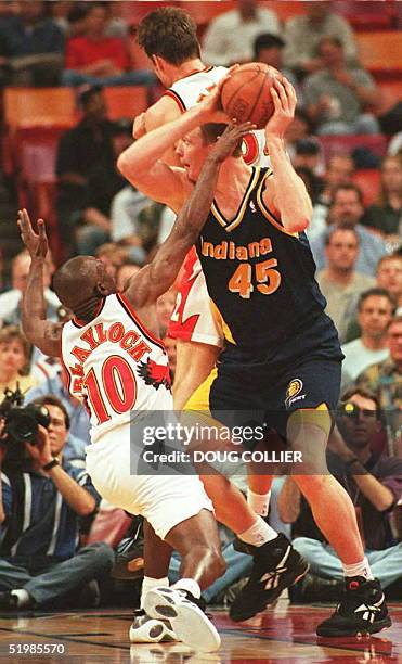 Indiana Pacers Rik Smits tries to shoot thru the double team efforts of Atlanta Hawks Mookie Blaylock and Christian Leattner during game four of...