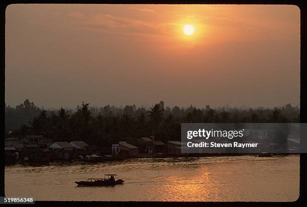 barges carry rice down saigon river - saigon river stock pictures, royalty-free photos & images