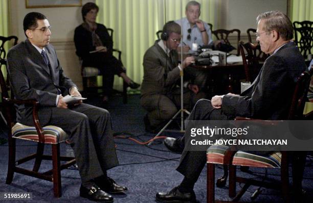 Arab satellite station Al-Jazeera's Washington bureau chief Hafez Al-Mirazi interviews US Defense Secretary Donald Rumsfeld 16 October 2001 at the...
