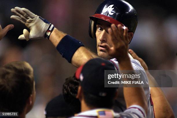 Surhoff of the Atlanta Braves is congratulated by teammates after hitting a two-run homer in the eighth inning against the Arizona Diamondbacks in...