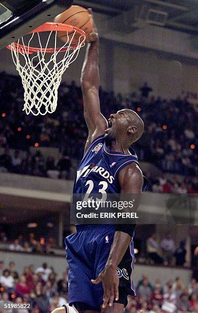 The Washington Wizards' Michael Jordan slam dunks the ball during their 23 October pre-season NBA game against the New Jersey Nets at the BI-LO...
