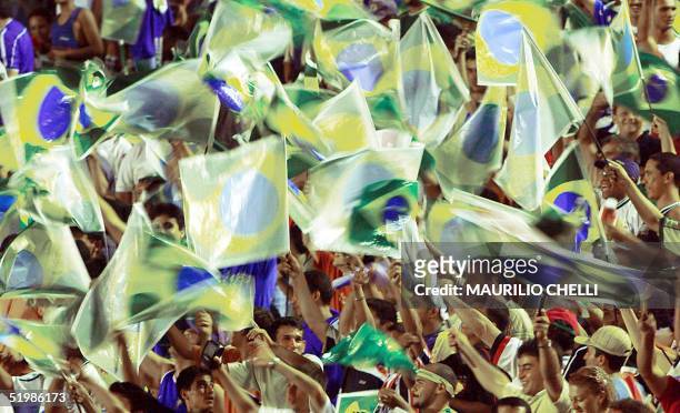 Brazilian soccer fans are seen waiving their flags in Sao Luis 14 november 2001. Aficionados brasilenos agitan banderas nacionales antes del inicio...