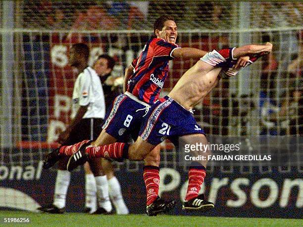 Soccer player from San Lorenzo, Lucas Pusineri and Guillermo Franco celebrate their third goal against Corinthians in Buenos Aires, 28 November 2001....
