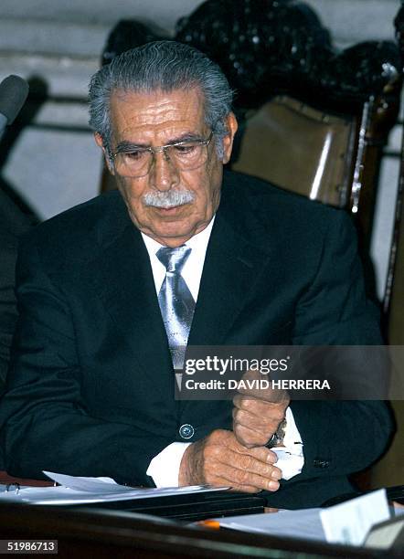 The ex-dictator Efrain Rios Montt adjusts his jacket during the meeting to reelect the third Congressional president, 14 January 2002 in Guatemala...