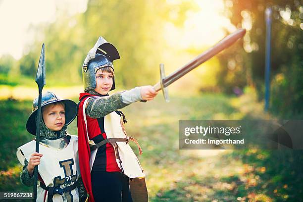 kids dressed up as knights playing outdoors - knight stock pictures, royalty-free photos & images
