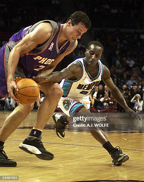 Memphis Grizzlies' Brevin Knight reaches in against Phoenix Suns' Tom Gugliotta during the first quarter, 21 February 2002, at The Pyramid in...