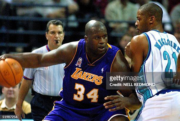 Los Angeles Lakers center Shaquille O'Neal looks for room to drive around Charlotte Hornets center Jamaal Magloire in the first half at the Charlotte...